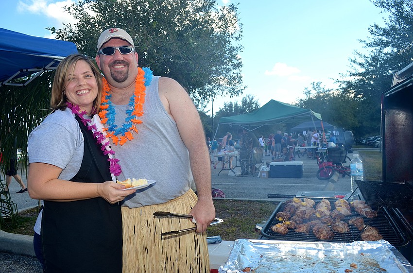 Sam and Steve Kagy take a break from grilling to say 