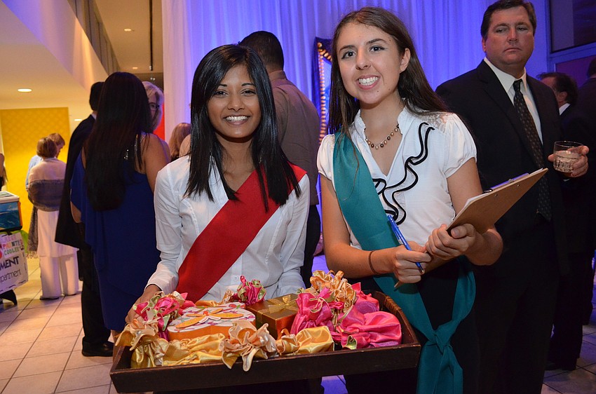 Pine View students Usha Kadiya and Grace Wickerson pass out tickets to guests for a chance to win a prize.