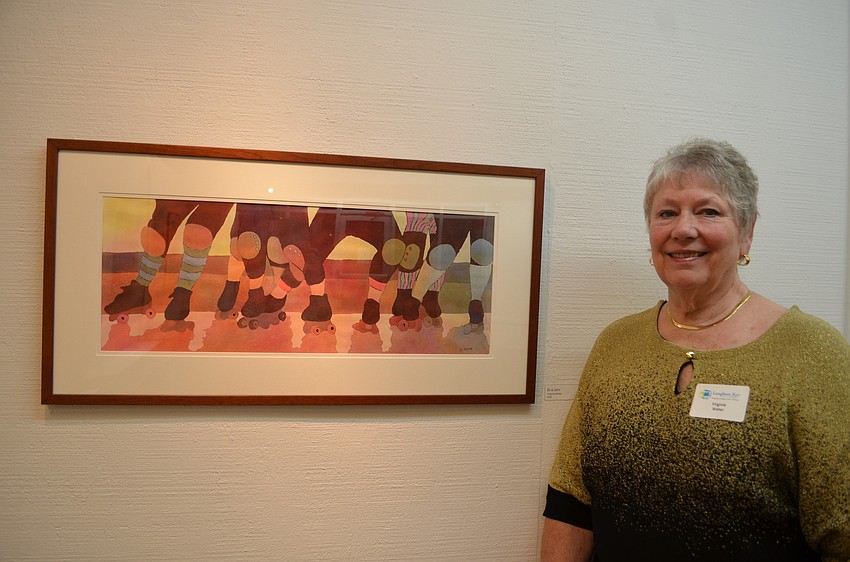 Virginia Weber with her painting titled â€œIn a Jam,â€ a depiction of women on a roller derby team.