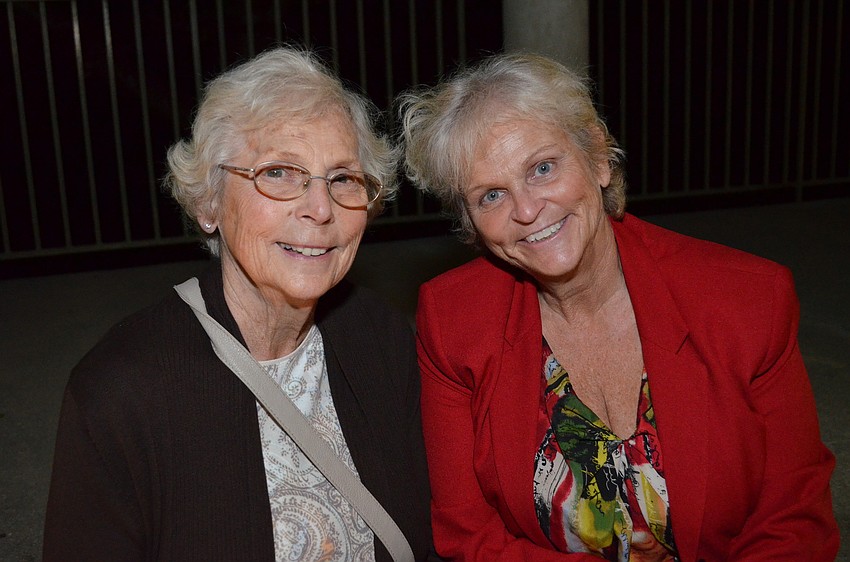 Nancy Shaughnessy and her daughter Margaret Shaughnessy sit beneath the pergola on the property for the White Cottage at Historic Spanish Point.