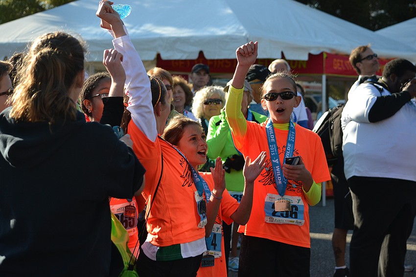 Members of the McIntosh Middle School Walk/Run Club celebrate being awarded the largest team to participate in the race.