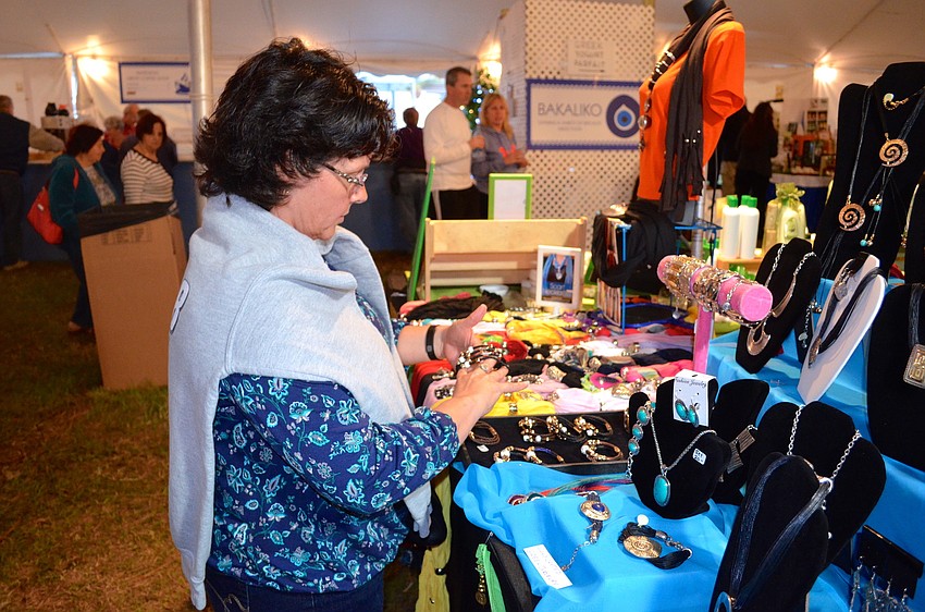 Becky Clark finds a bracelet she plans to purchase from the Greek marketplace.