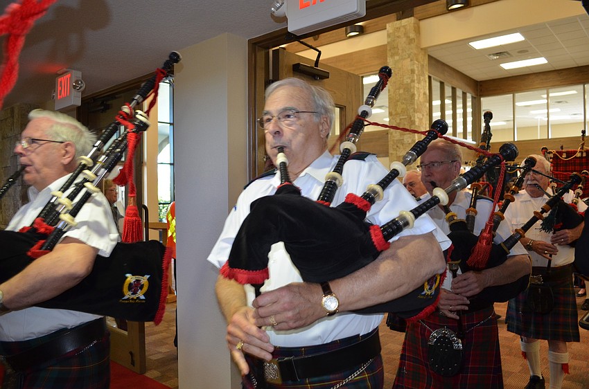 The St. Andrewâ€™s Pipes & Drums Band of Tampa Bay begins its procession.