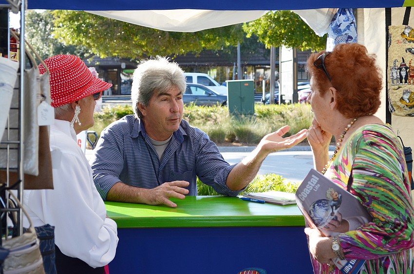Dee Wright, Bill Toledo and Jane Zepf catch up in the KLT Sewing booth at the craft festival.