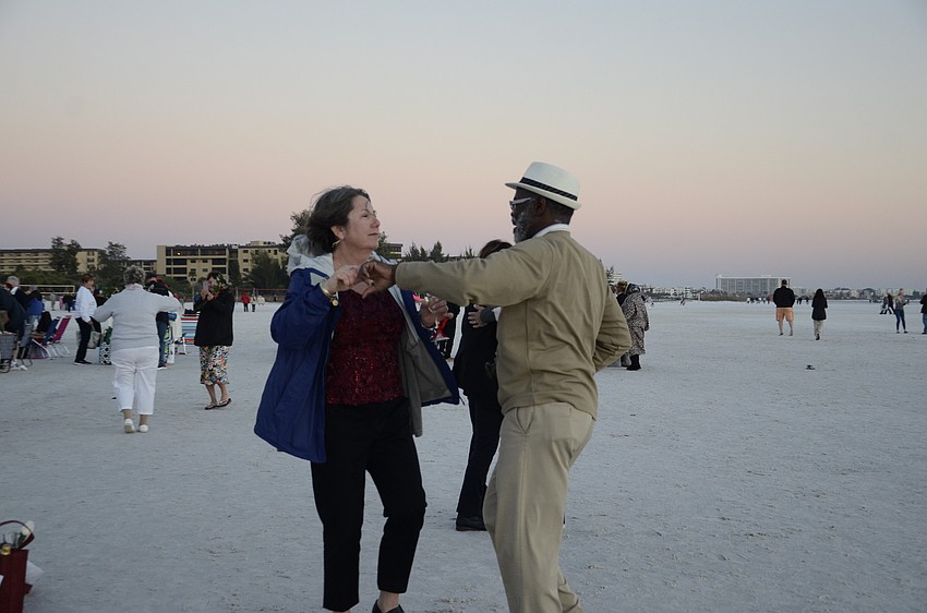 Helene and Andy Scott dance on the beach.