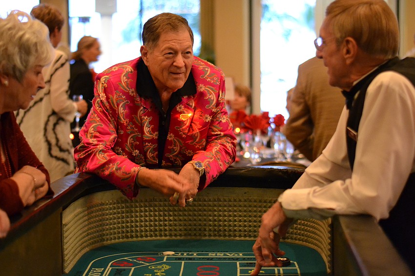Bruce Lesser places a bet on a game of craps.