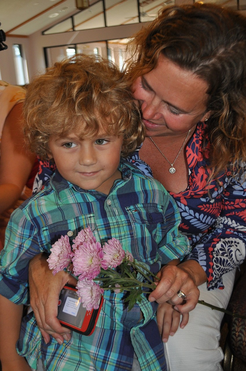 Hunter Montague gives his mom, Carrie, flowers.