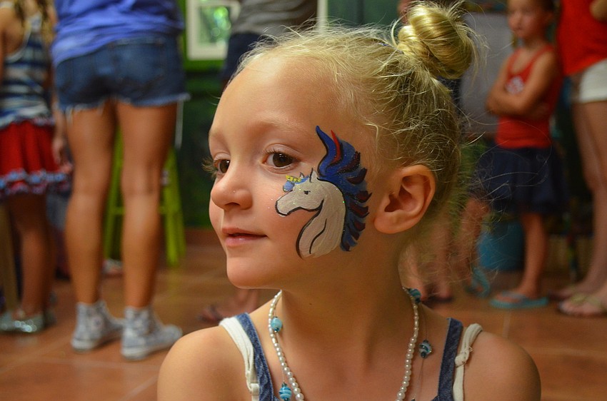 Georgia Salvesen shows off her unicorn face paint.