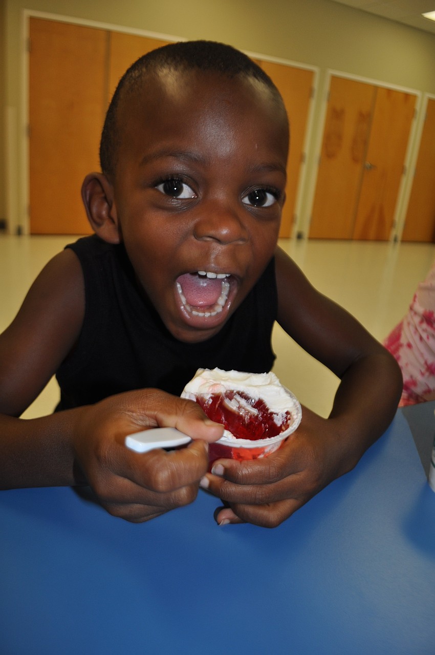 Byron Milligan, 4, eats Jello with his sister, Dajah, 6, not pictured.
