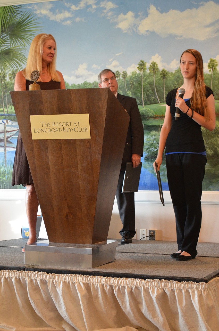 Anastasia Fusco, University of Florida, is awarded an academic scholarship by Scholarship Committee Chair Susan Philips and Longboat Kiwanis Club President Richard Crawford.