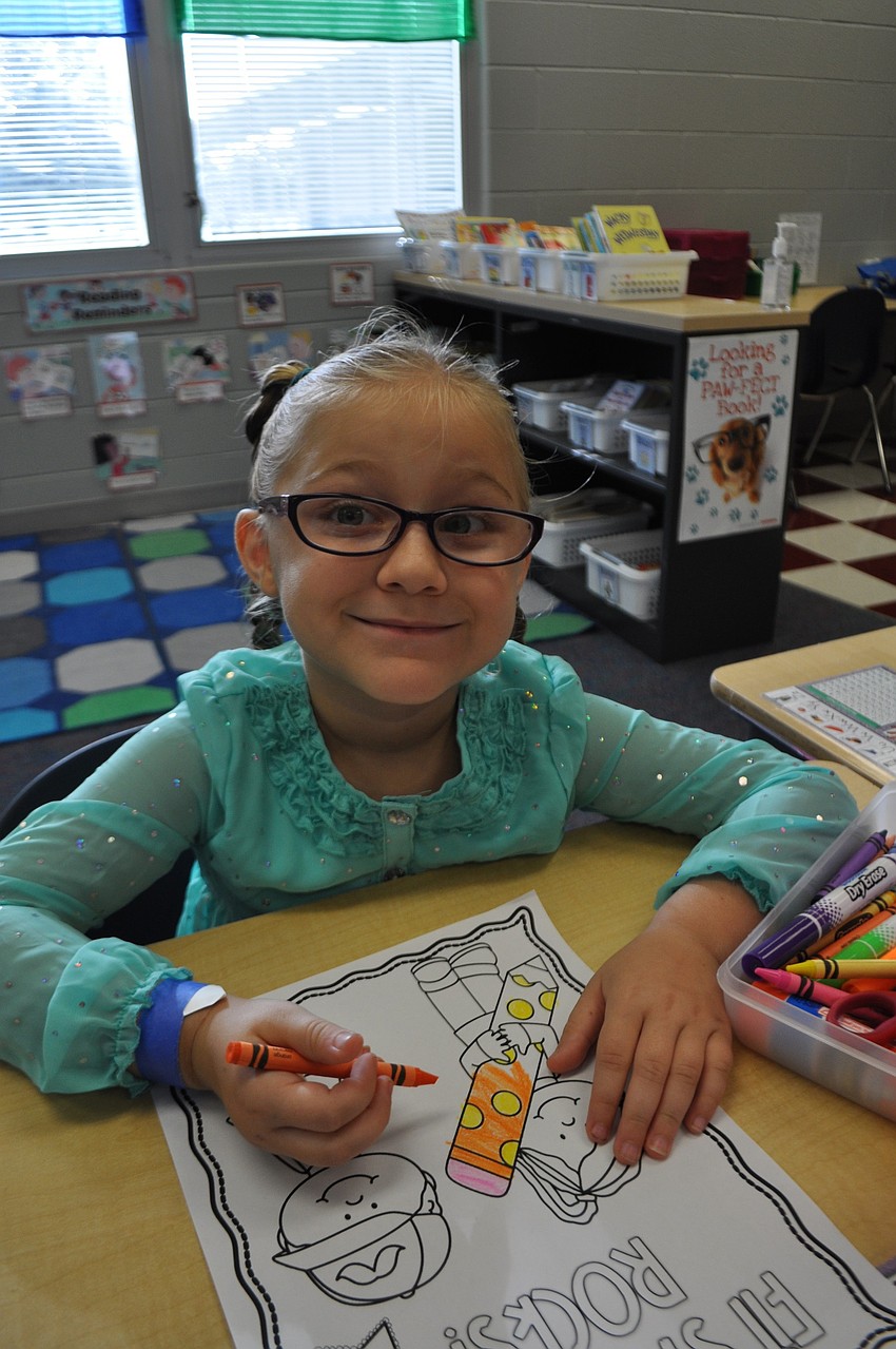 Melody Klaymeier, 6, colors in her classroom.