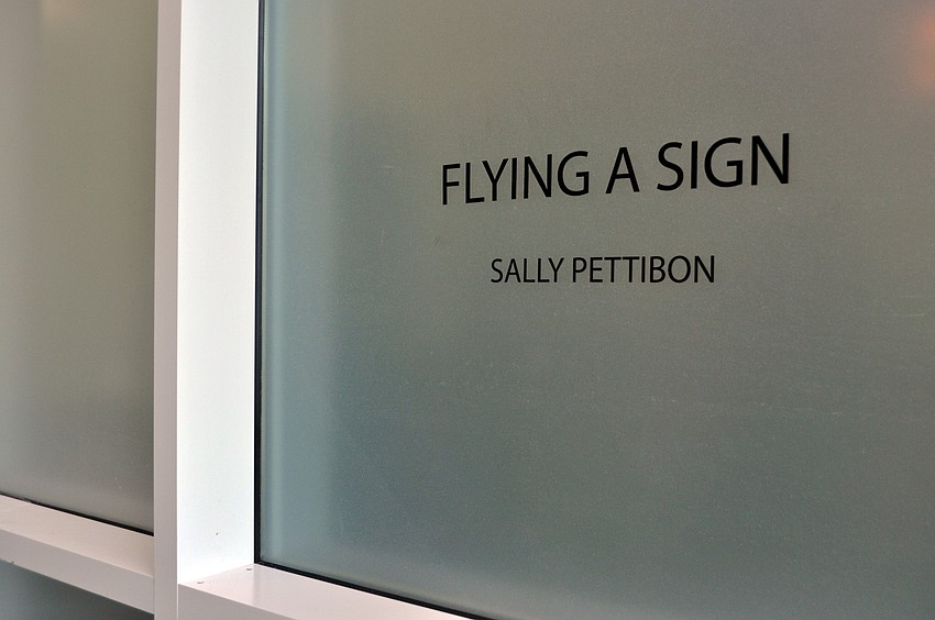 Guests gathered at Two Columns Gallery Friday, Aug. 22, for Sally Pettibonâ€™s â€˜Flying a Signâ€™ exhibition.