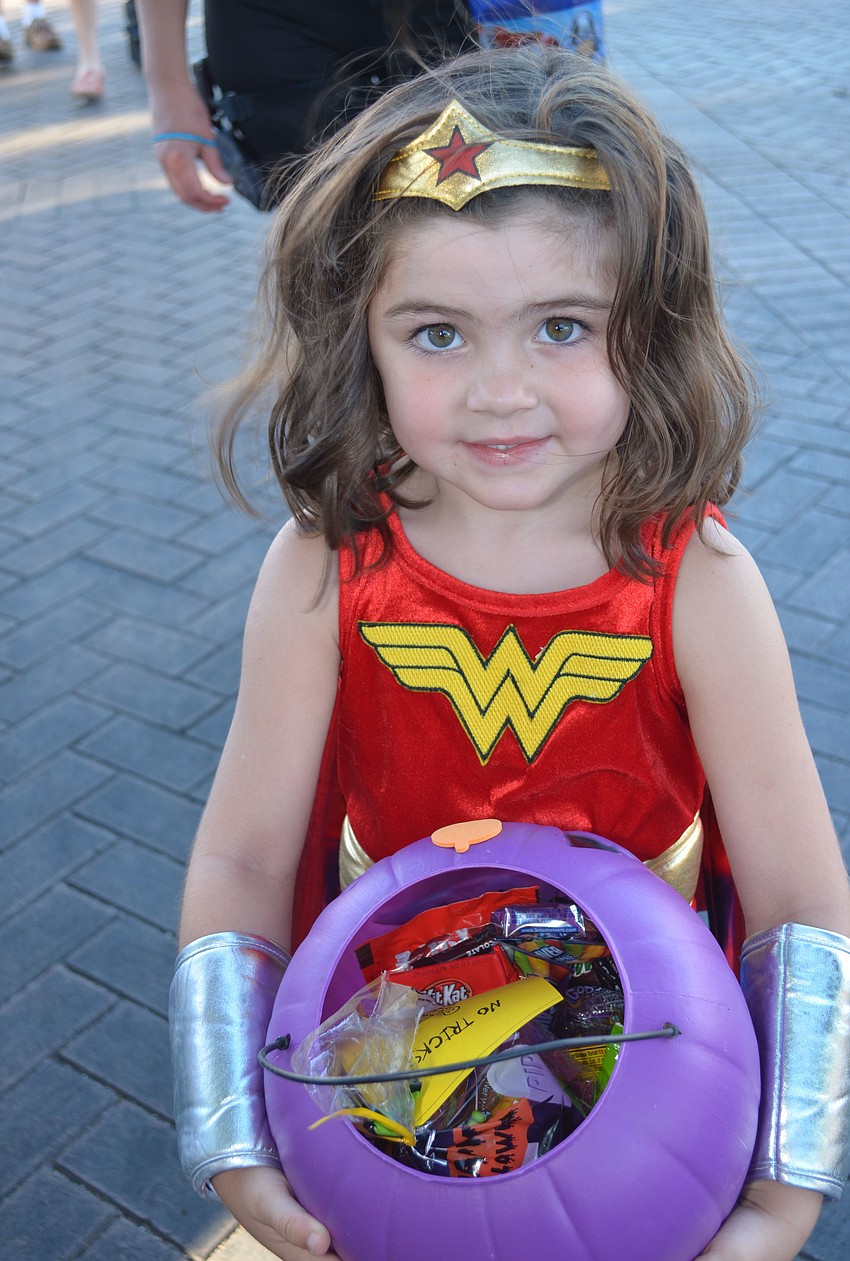 Scarlett W shows off how much candy she collected at Safe Treats.