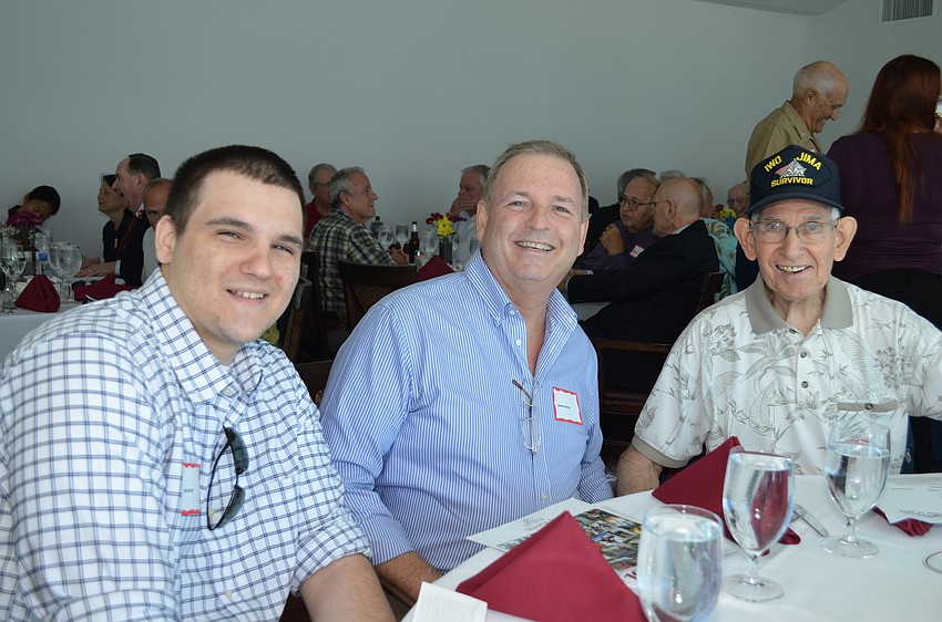 Joseph Royer sits with his father and grandfather David and Joe at the luncheon.
