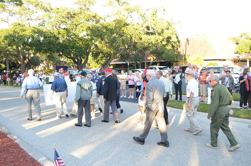 Korean War era veterans march in the parade.