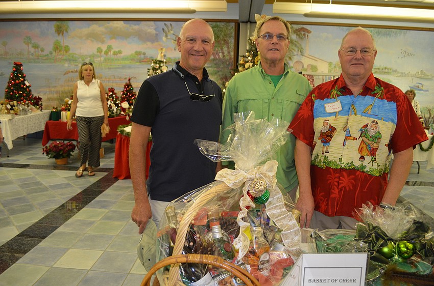 Michael Landis, Jim McGuire and Russ Gill sell raffle tickets from the Menâ€™s Club.