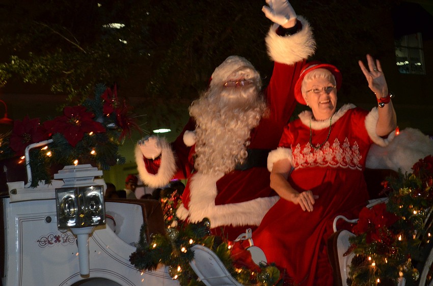 Santa Claus and Mrs. Claus wave to the crowd during the holiday parade.