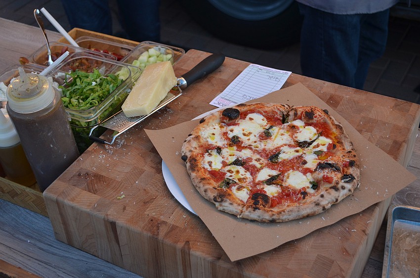A fresh pie from Polpo Pizza Company's brick oven