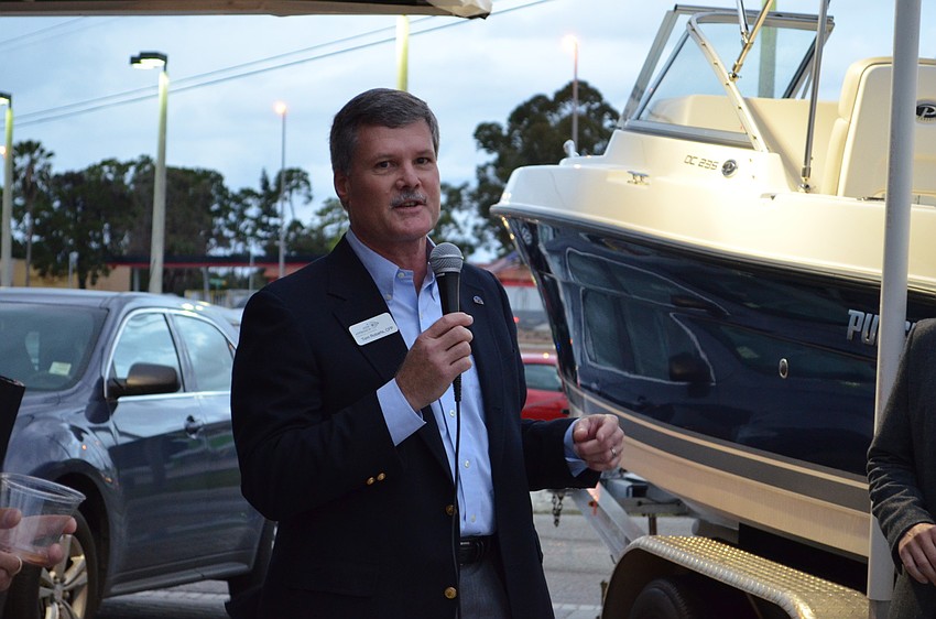 Tom Roberts accepts the Insignia Award for excellence in customer service.