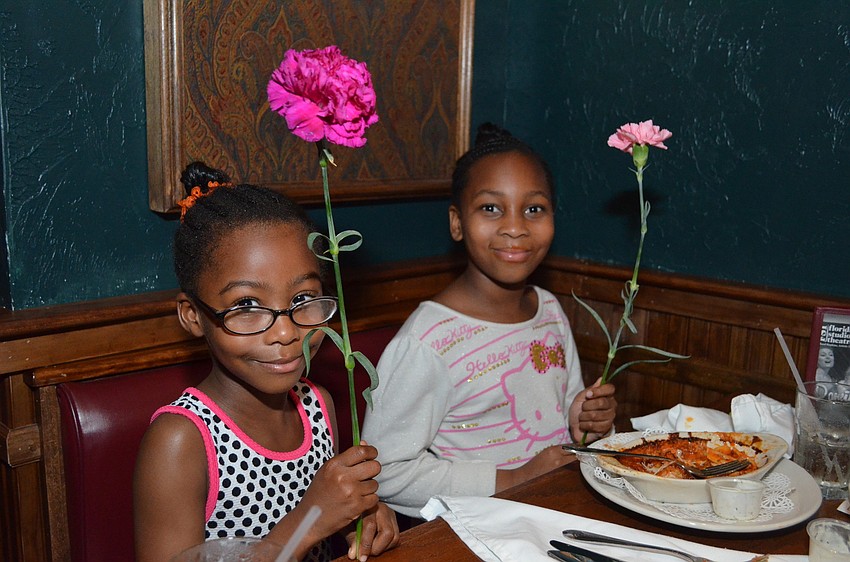 Maliyah and Azariah Phillips show off their flowers from their date.
