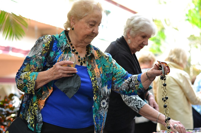Pat Pelino browses the jewelry selection.