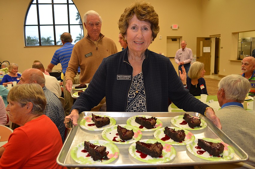 Patty Dunham brings chocolate cake to her table.