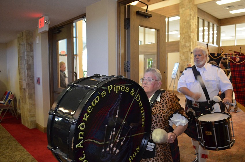 The St. Andrewâ€™s Pipes & Drums Band of Tampa Bay begins its procession.