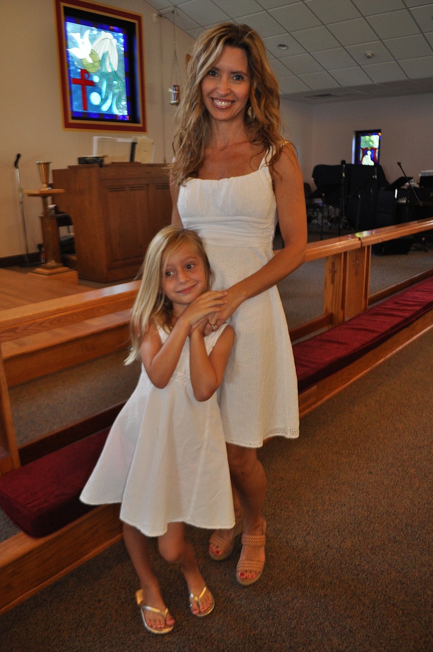 Olivia and Mary Kavanshansky wear matching dresses to the ceremony.