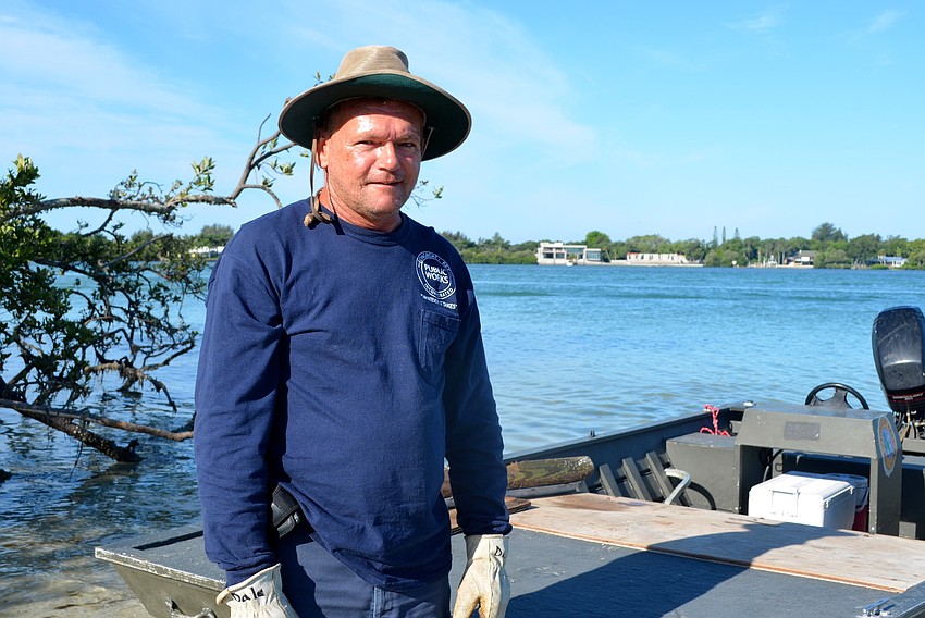 Dale Wyman, of Longboat Key Public Works, joins in the cleaning effort.