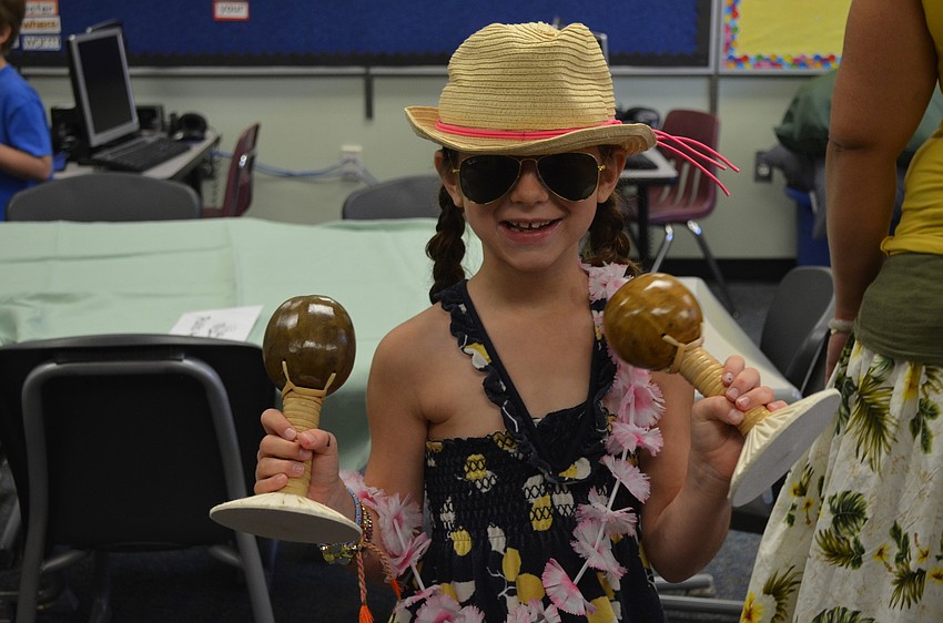 Lila Tack plays with the Hawaiin instruments uli uli.
