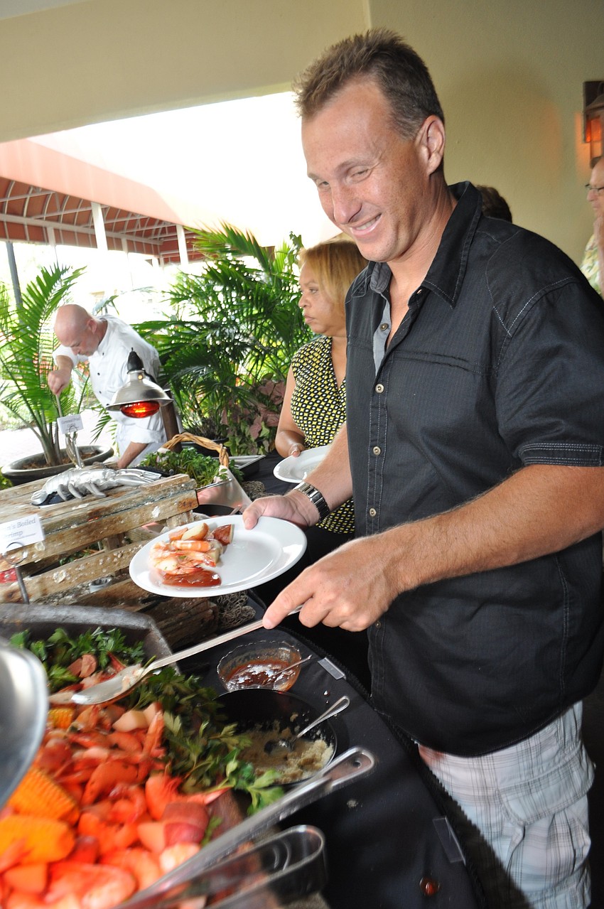 Carl Severs loads up on fresh shrimp.