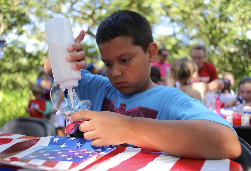 Cameron Buitrago, 8, makes sand art.