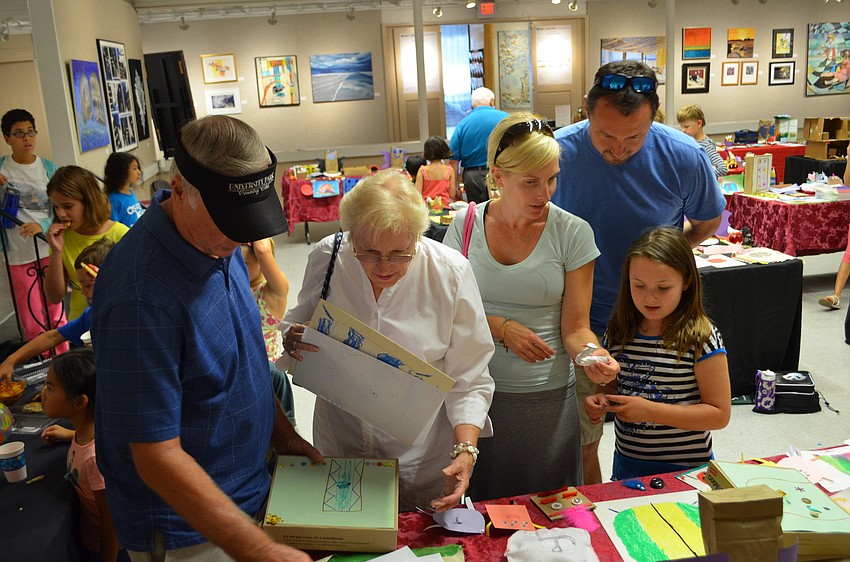 Bob and Jane Paulishak and Jill and Sean Martin come to see Morgan Martinâ€™s art at her art opening