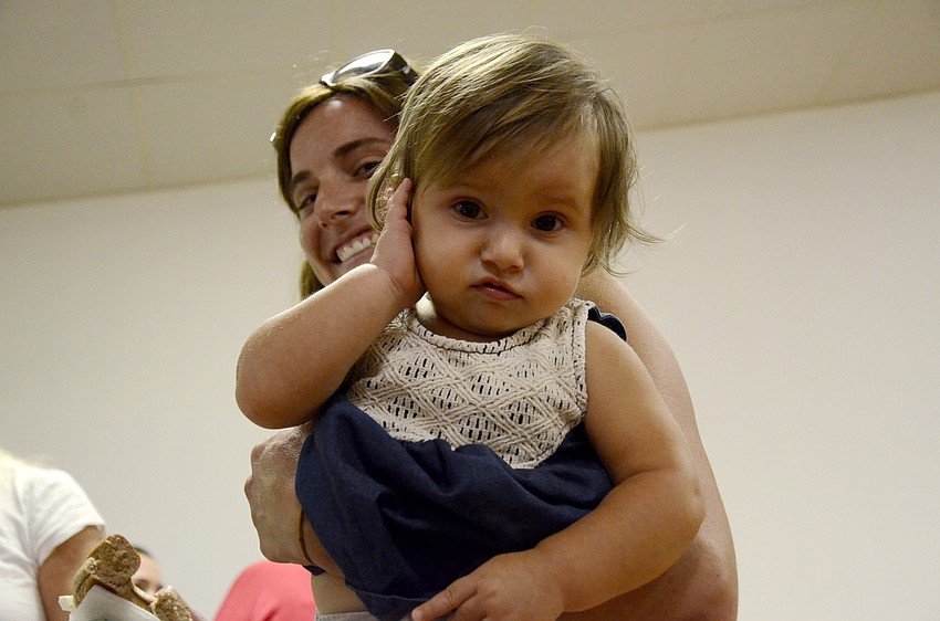 Raquel Vieira, 13 months, watched as her mom, Jaime, and her brother Benjamin chatted with teachers and other parents.