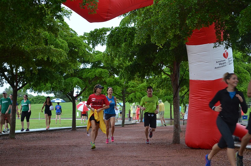 Runners reach the finish line for the 2014 American Heart Association Heart Walk.