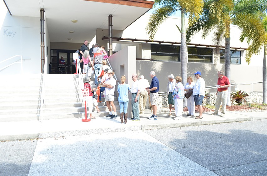 Residents stand in line at Town Hall to vote