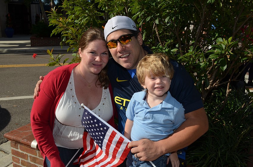 Cindy and Joseph Neunder sit with their son Michael at the Veterans Day Parade.