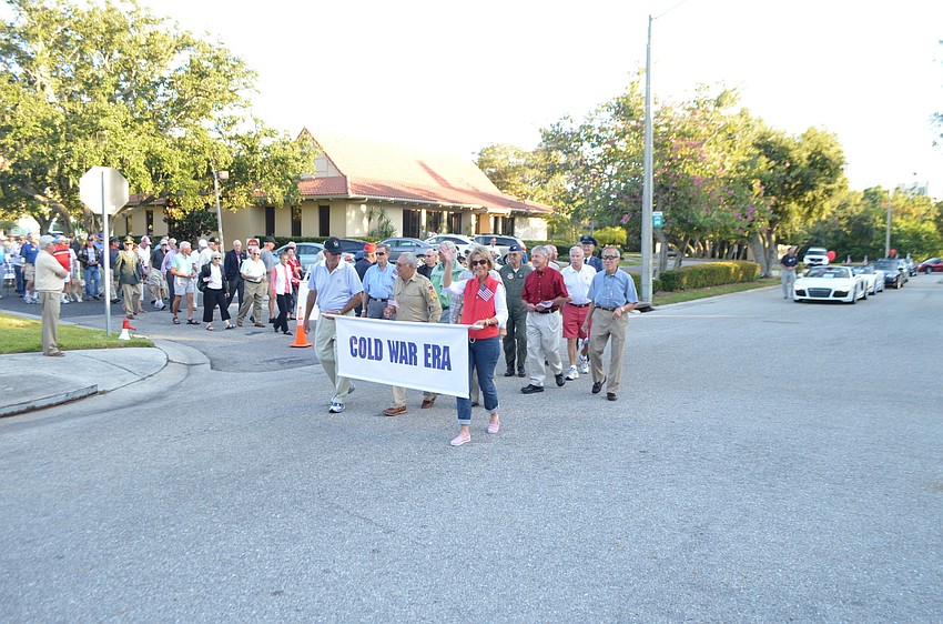 Cold War era veterans march in the parade.