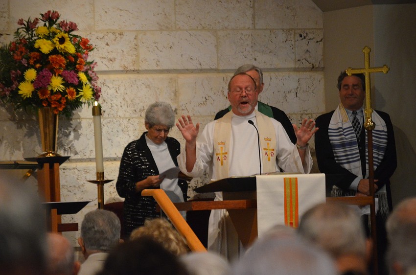 The Rev. Mark Bernthal, of St. Armands Key Lutheran Church, closes the service with a benediction.