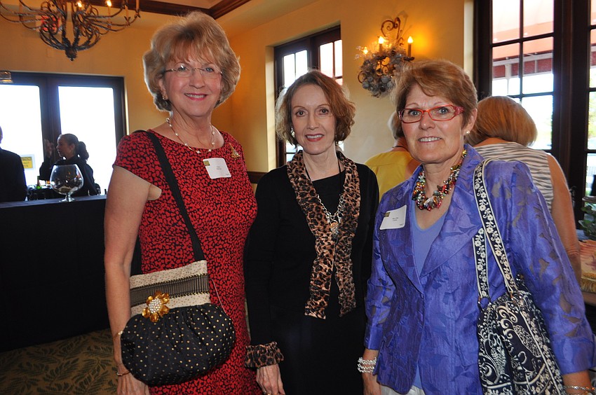 Elaine Steinfurth shows off a purse made by Mary Allmann, a vendor. They are pictured with Mary Bea Collins, right.