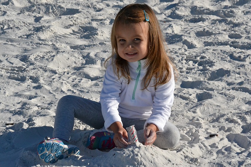Jessie Ochsendorf builds a sand castle at the Sandy Claws Beach Run.
