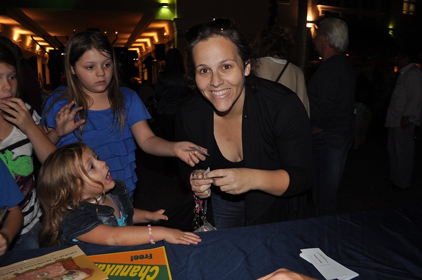 Jennifer Baty, surrounded by her four children, registers for the raffle.