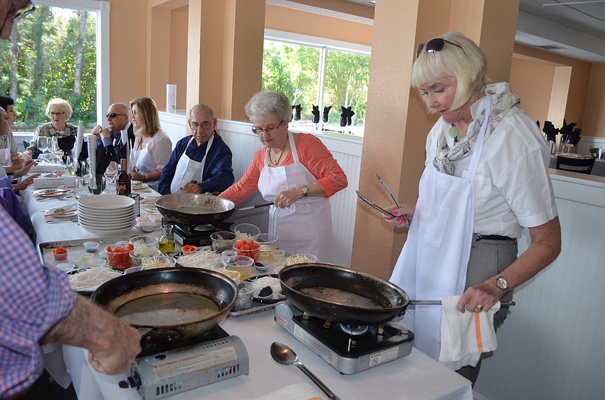 Attendees prepare spicy mint noodles with shrimp.