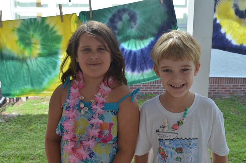 Rio Taylor and Mark Ruster wait to tie die.