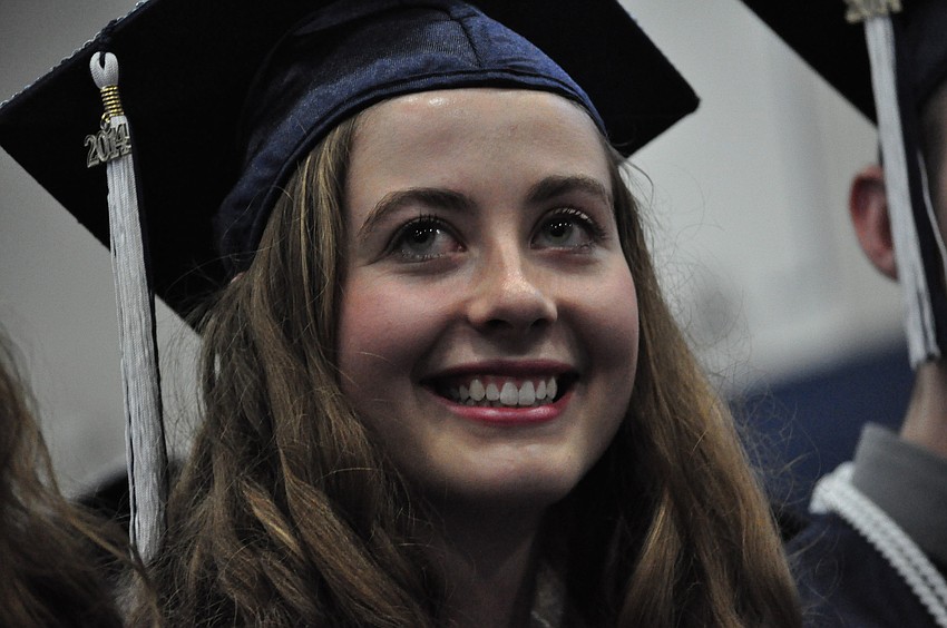 Emily Camire laughs as she listens to student speaker Quinton Fitzgerald, whom she introduced to the audience.