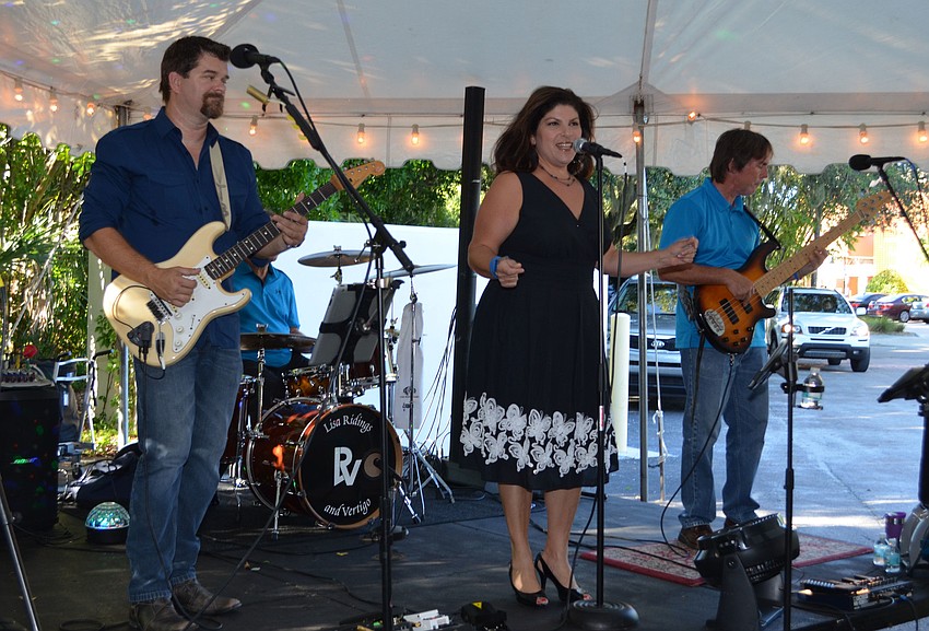 The band Vertigo featuring Lisa Ridings performs for guests at the Pillar of Hope Open House for the Child Protection Center
