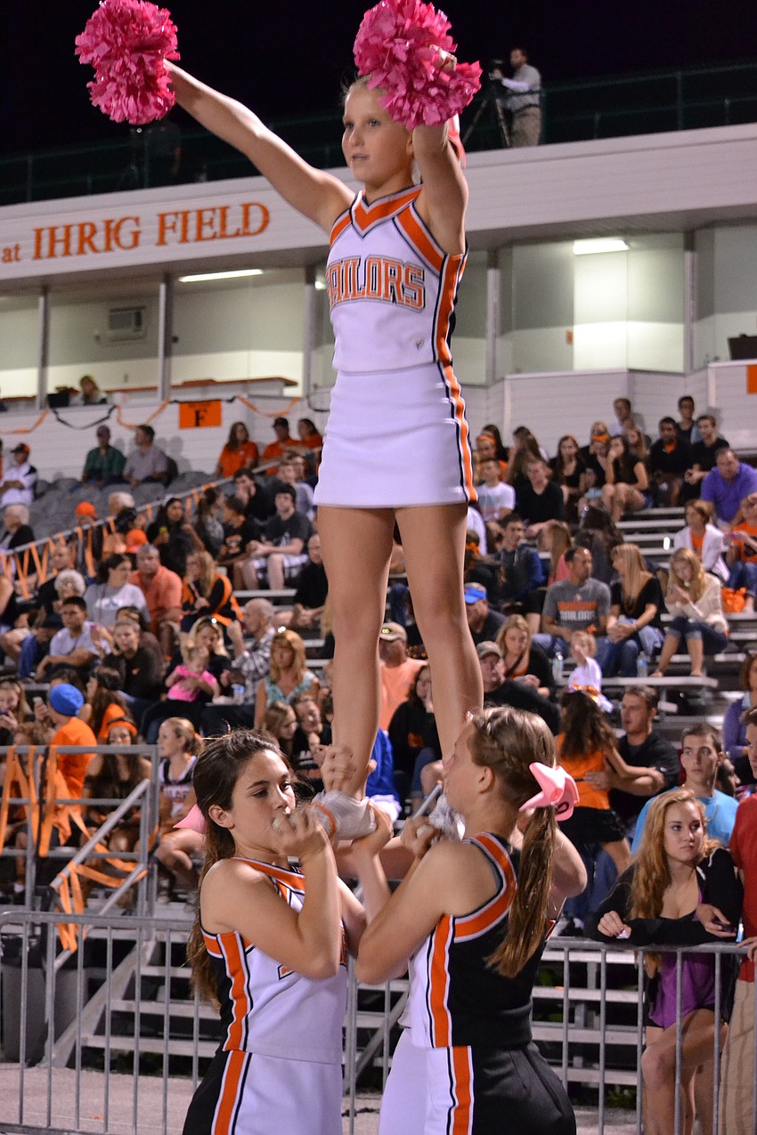 Cheerleaders Juliette Williams, Savannah Gordon, Hannah Orndorff and Hannah Wheeler lift into a half.