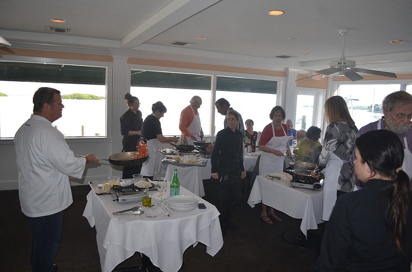 Owner Tommy Klauber instructs guests on making spicy mint noodles with shrimp.