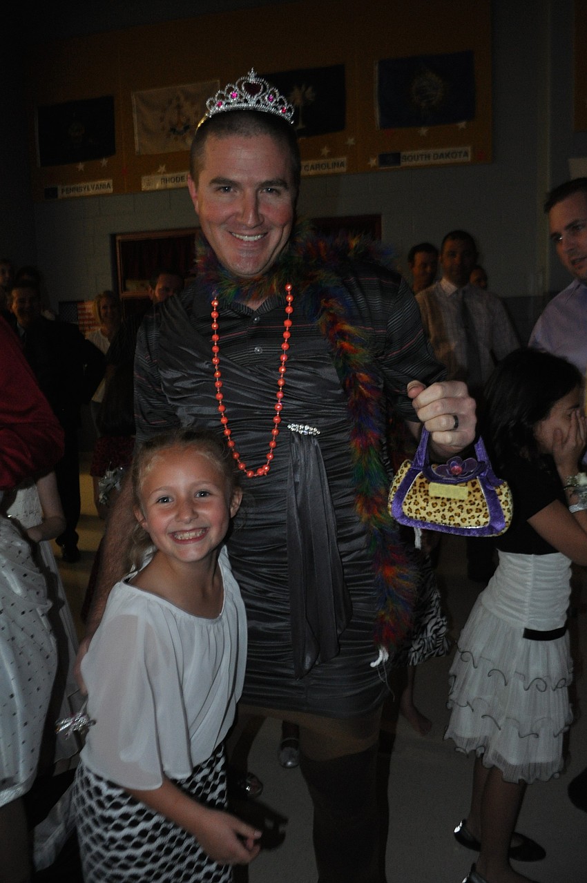 Scott Fleeman shows off the accessories his daughter, Briley, helped put on him during the dress-up-daddy race.