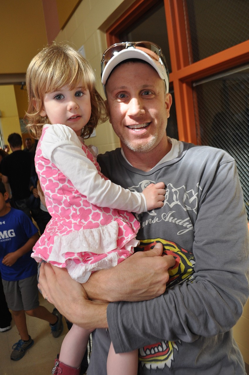Daphne and Jason Quintal dance in the hallway.